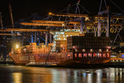 Illuminated commercial dock against sky at night