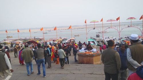 People at market against sky in city