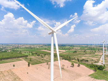 Windmill on field against sky