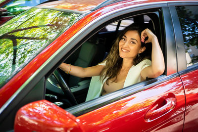 Portrait of young woman in car