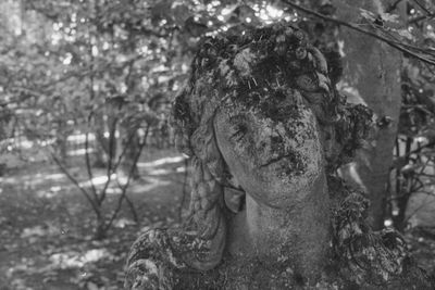 Close-up portrait of woman with tree