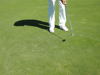 Low section of man standing on golf course