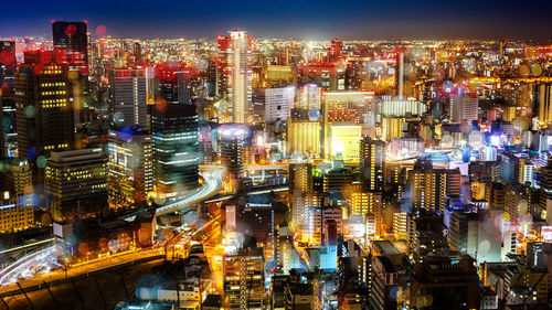 High angle view of illuminated modern buildings in city at night