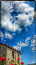 Low angle view of built structure against cloudy sky