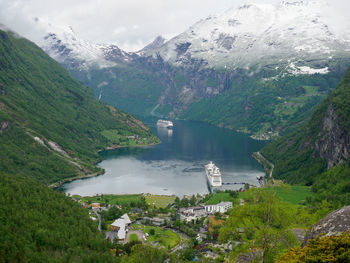 High angle view of river amidst mountains against sky