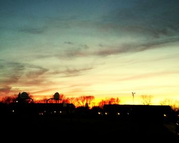 Silhouette of trees against dramatic sky