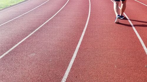Low section of person running on road