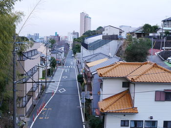 High angle view of street amidst buildings against sky