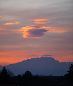 Scenic view of silhouette mountains against sky during sunset