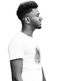 Midsection of young man looking away against white background