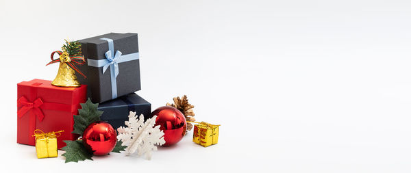 Christmas decorations on box against white background
