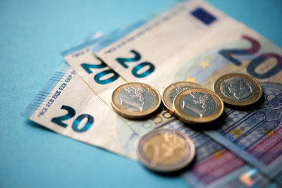 High angle view of european currency on blue background