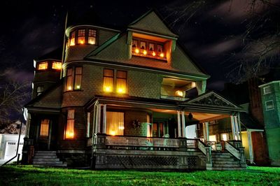 Illuminated house against sky at night