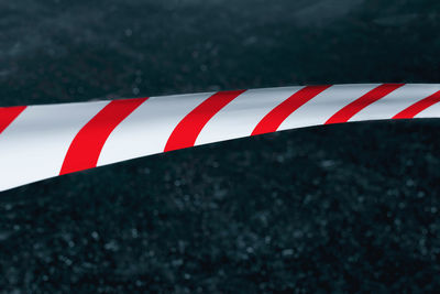 Close-up of red flag on road against wall