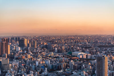 High angle view of illuminated buildings against sky during sunset