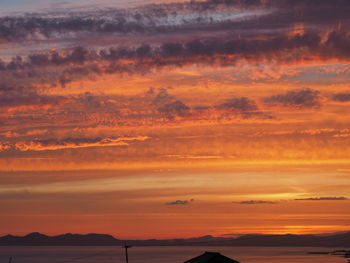 Scenic view of dramatic sky over silhouette landscape