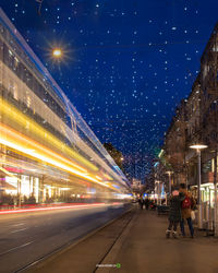 Light trails on road in city at night