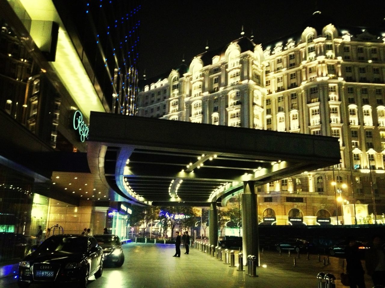 night, illuminated, architecture, built structure, building exterior, transportation, city, street, car, land vehicle, city life, mode of transport, incidental people, lighting equipment, street light, the way forward, building, in a row, road, travel