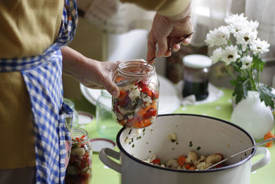 Close-up of woman preparing pickle at home