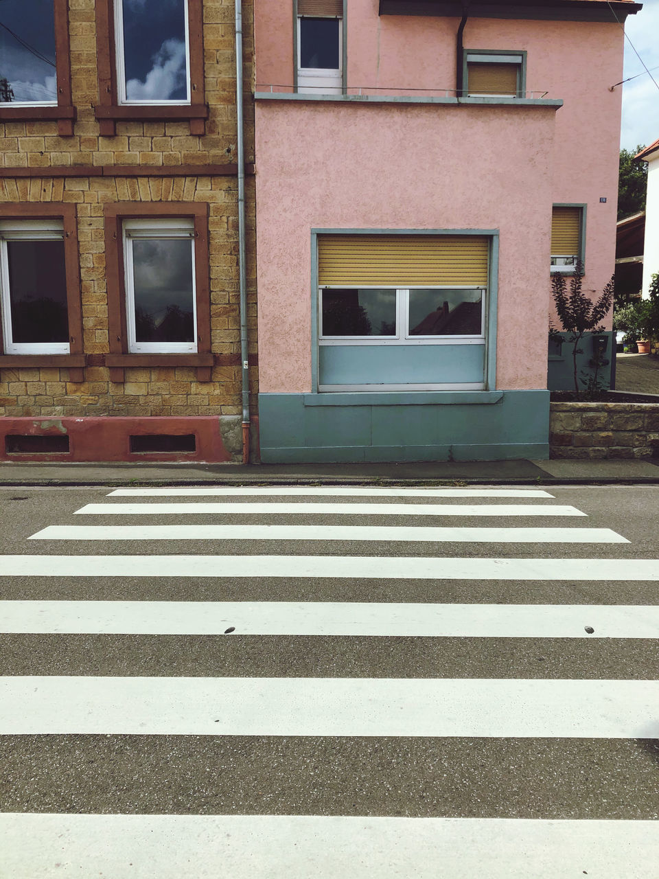 ZEBRA CROSSING ON ROAD AGAINST BUILDINGS