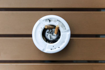 Close-up of cigarette in ashtray at table