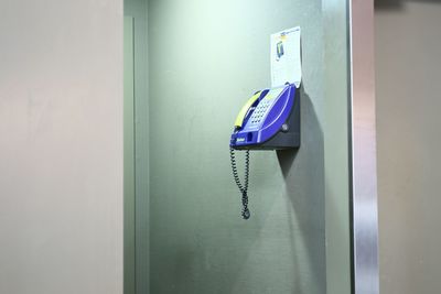 Pay phone mounted on wall