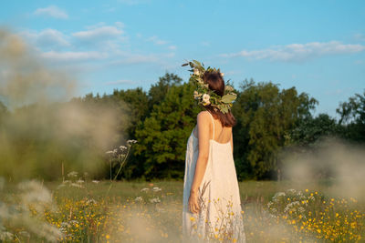 Woman wearing wrath standing on field