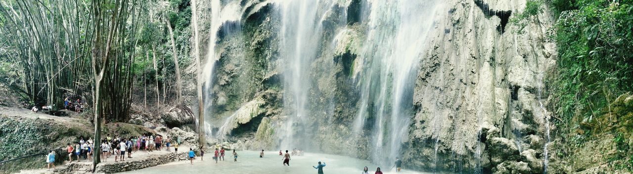 large group of people, waterfall, motion, water, lifestyles, men, leisure activity, flowing water, person, tourist, tourism, tree, long exposure, vacations, travel destinations, travel, mixed age range, famous place, beauty in nature