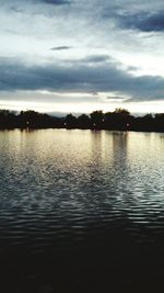 Scenic view of lake against cloudy sky