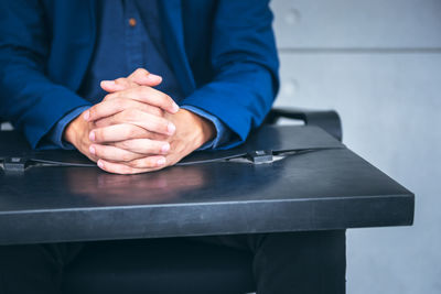 Midsection of man working on table