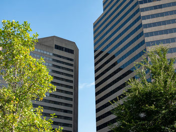 Low angle view of modern buildings against clear sky