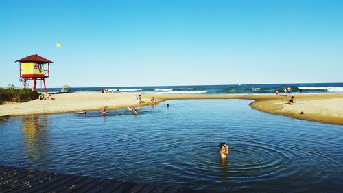 Scenic view of sea against clear blue sky