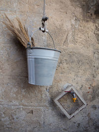 Outdoor furniture consisting of a metal bucket hanging on a wall