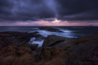 Scenic view of sea against storm clouds