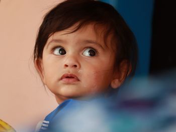 Close-up portrait of cute baby boy looking away