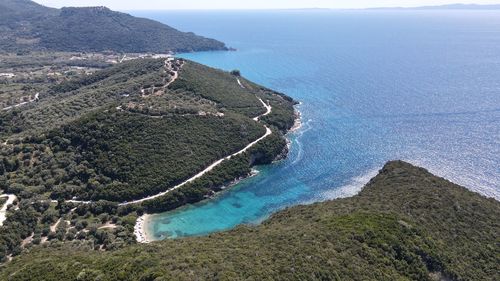 High angle view of land and sea against mountains