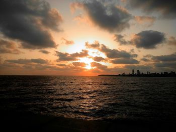 View of sea against cloudy sky during sunset