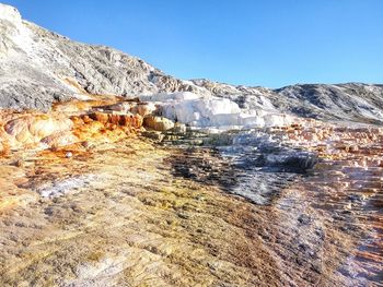 Scenic view of mountain against blue sky