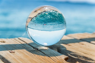 Close-up of water on table against sea