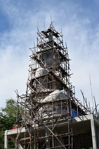 Low angle view of construction site against sky