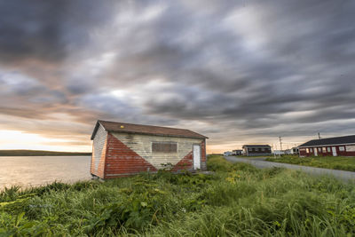 Built structure on field against sky