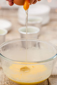 Close-up of hand pouring drink in glass