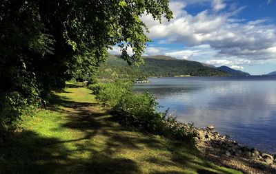 Scenic view of lake against cloudy sky