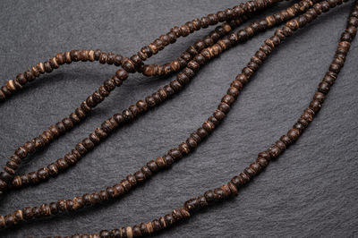 High angle view of beads on slate