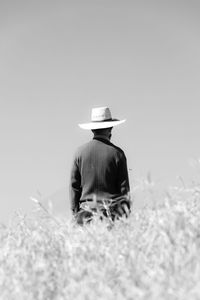 Black and white photograph of mysterious man  wearing hat