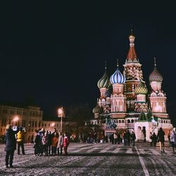 People in illuminated city at night