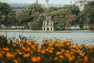 Scenic view of lake by building against sky