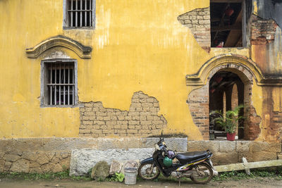 Old building against yellow wall