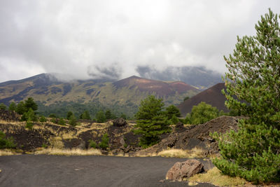 Empty road with mountains in background