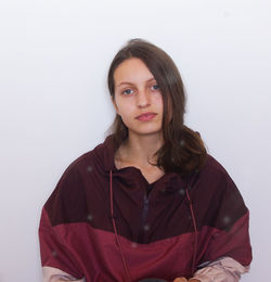 Portrait of young woman against white background